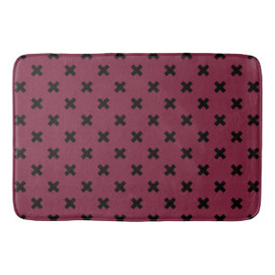 Black cross stitches on mulberry bath mat