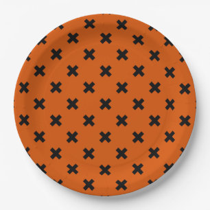 Black cross stitches on orange paper plates