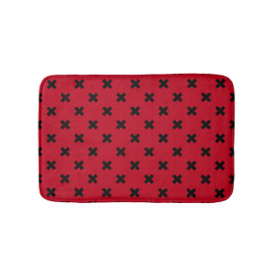 Black cross stitches on red bath mat