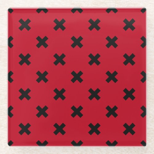 Black cross stitches on red glass coaster