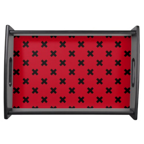 Black cross stitches on red serving tray