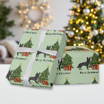 Black German Shepherd And Festive Christmas Tree Wrapping Paper<br><div class="desc">Destei's original cartoon illustration of a black color German Shepherd breed dog. The dog is standing by a festive Christmas tree decorated with red and yellow ornaments, a white pearl garland and a yellow star that is placed on the top of the tree. There are also two wrapped presents by...</div>