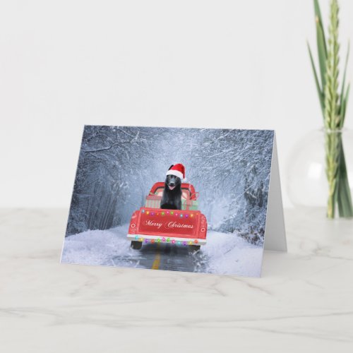 Black German Shepherd Snow sitting in Christmas Card