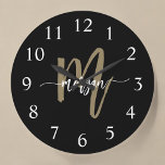 Black Gold Modern Script Monogram Name  Large Clock<br><div class="desc">Make a statement with the Black and Gold Modern Script Monogram Name Large Clock. Featuring a sleek black design with a bold gold monogram in a modern script font, this large wall clock combines luxury and functionality. With its elegant design, it seamlessly enhances any living room, office, or bedroom while...</div>