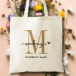 Black Gold Monogram Initial Script Name Heart Tote Bag<br><div class="desc">Introducing the Black Gold Monogram Initial Script Name Heart Tote Bag, a chic and elegant accessory perfect for weddings, bridesmaids, maid of honor, or even the bride herself. This stylish tote features a stunning black and gold color scheme that adds a touch of sophistication to any outfit. The monogrammed initial...</div>
