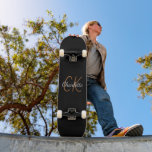 Black gold monogram script elegant minimalist skateboard<br><div class="desc">A classic black background. Personalize and add a name and monogram initials. The name is written with a modern hand lettered style script. White and golden letters.</div>