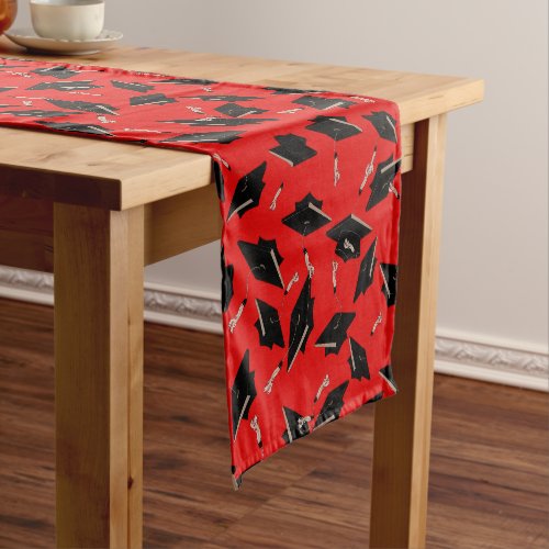 Black Graduation Caps Tossed in the Air on Red Short Table Runner
