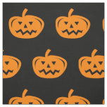 Black Halloween fabric with carved orange pumpkins