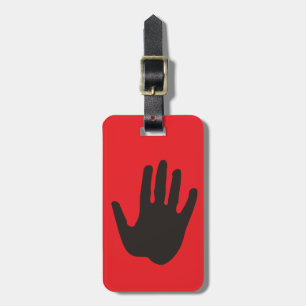 Black hand stop on red luggage tag