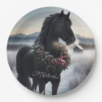 Black horse in the snow with Christmas wreath
