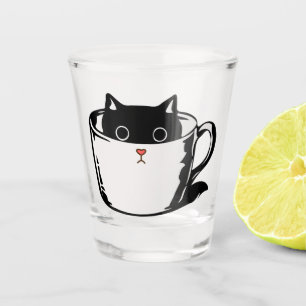 Black kitten with red nose hiding in a cup