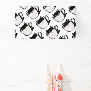 Black kitten with red nose hiding in a cup banner