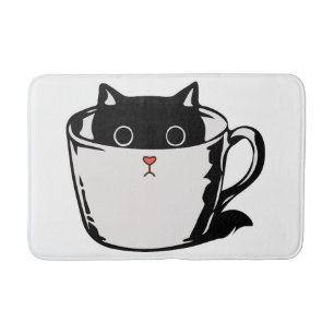 Black kitten with red nose hiding in a cup bath mat