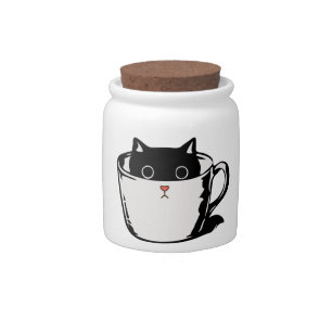 Black kitten with red nose hiding in a cup candy jar