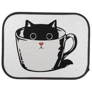 Black kitten with red nose hiding in a cup car floor mat