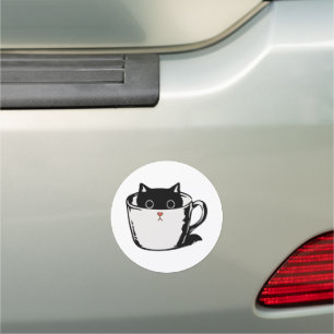Black kitten with red nose hiding in a cup car magnet