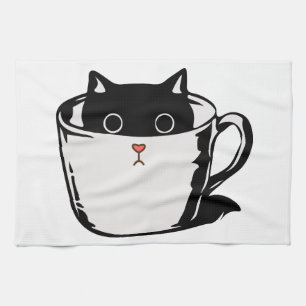 Black kitten with red nose hiding in a cup kitchen towel