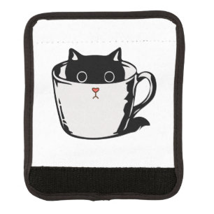 Black kitten with red nose hiding in a cup luggage handle wrap