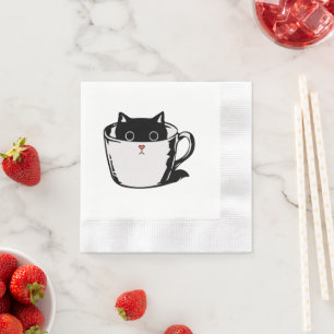 Black kitten with red nose hiding in a cup napkins