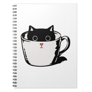 Black kitten with red nose hiding in a cup notebook