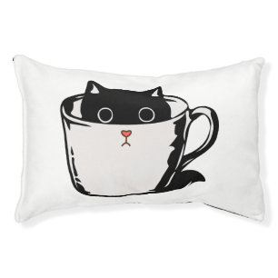 Black kitten with red nose hiding in a cup pet bed