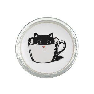 Black kitten with red nose hiding in a cup ring