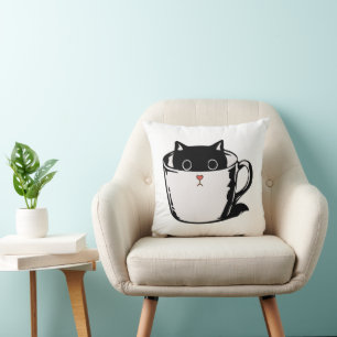 Black kitten with red nose hiding in a cup throw pillow