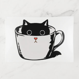 Black kitten with red nose hiding in a cup trinket tray