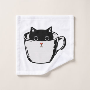 Black kitten with red nose hiding in a cup wash cloth