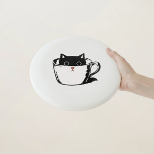 Black kitten with red nose hiding in a cup Wham-O frisbee