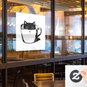 Black kitten with red nose hiding in a cup window cling