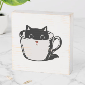 Black kitten with red nose hiding in a cup wooden box sign