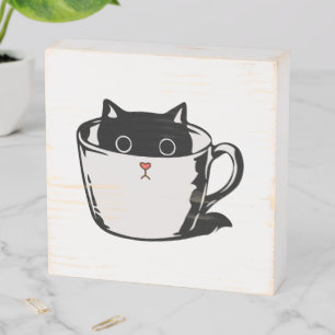Black kitten with red nose hiding in a cup wooden box sign