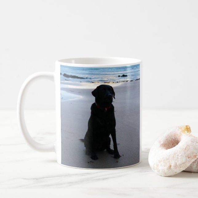 Black Labrador on a beach Coffee Mug (With Donut)