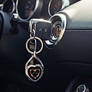 Black metal keychain with a pink heart and blush