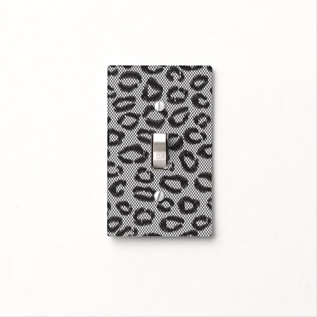 Black net lace with leopard pattern on white light switch cover (In Situ)