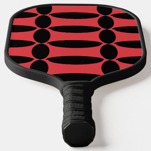 Black oval shapes on red pickleball paddle