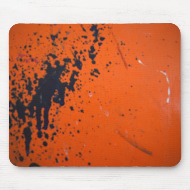 Black paint splatter on orange mouse pad (Front)