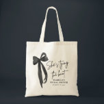 Black Pink Bow She's Tying the Knot Bridal Shower  Tote Bag<br><div class="desc">Add a stylish touch to your bridal shower with our Black Pink Bow She's Tying the Knot Bridal Shower Tote Bag! Featuring a chic black design with a feminine pink bow, this tote bag is perfect for carrying favors, gifts, or essentials for the special day. It's an elegant and practical...</div>