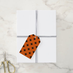 Black polka crosses on orange gift tags