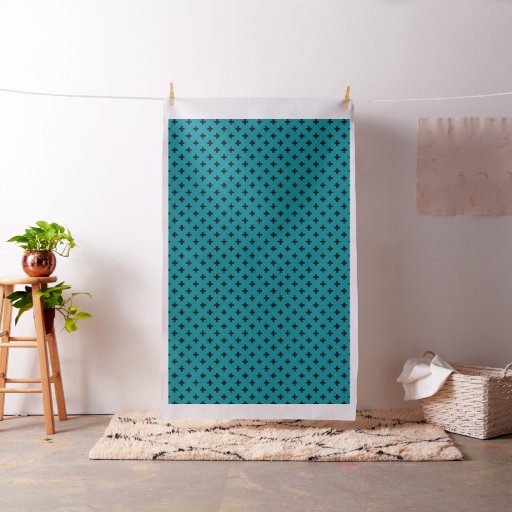 Black polka crosses on teal fabric