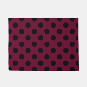 Black polka dots on burgundy doormat