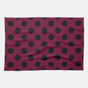 Black polka dots on burgundy kitchen towel