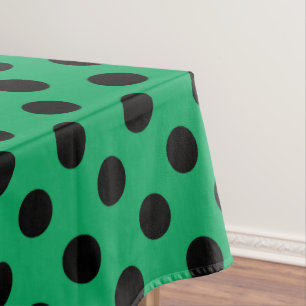 Black polka dots on fresh green tablecloth