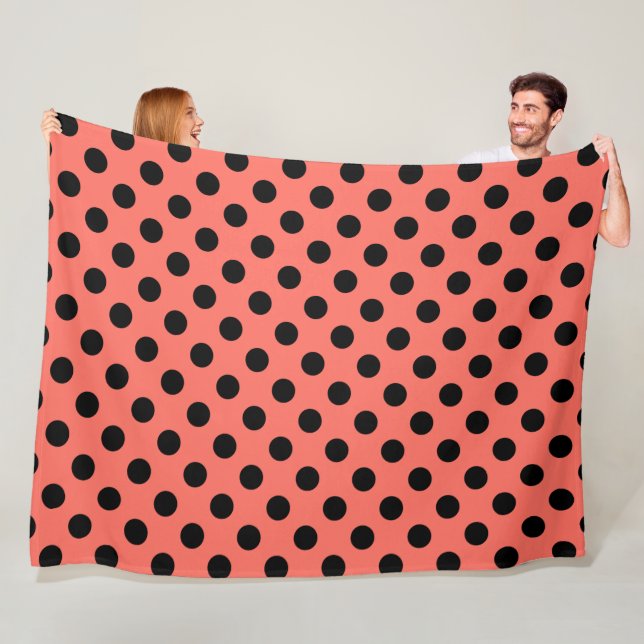 Black polka dots on living coral fleece blanket (In Situ)