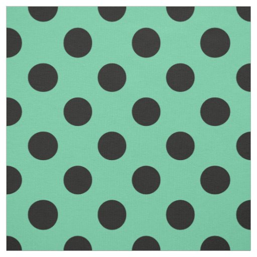 Black polka dots on mint green fabric