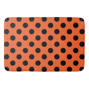 Black polka dots on orange bathroom mat