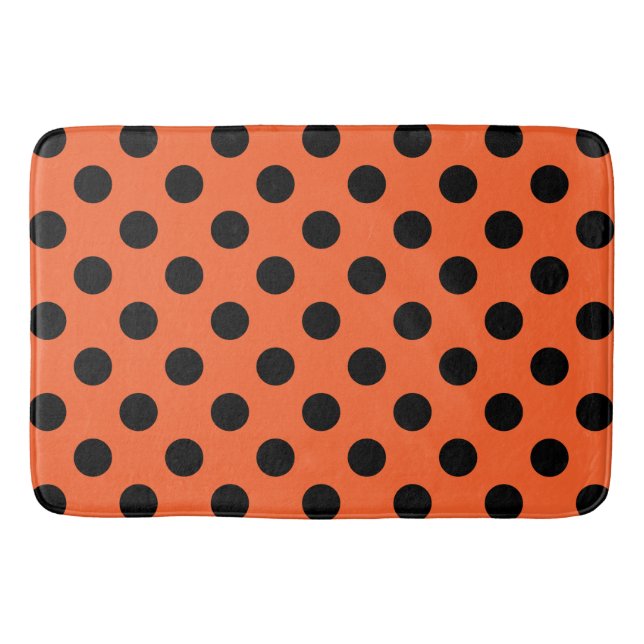 Black polka dots on orange bathroom mat (Front)