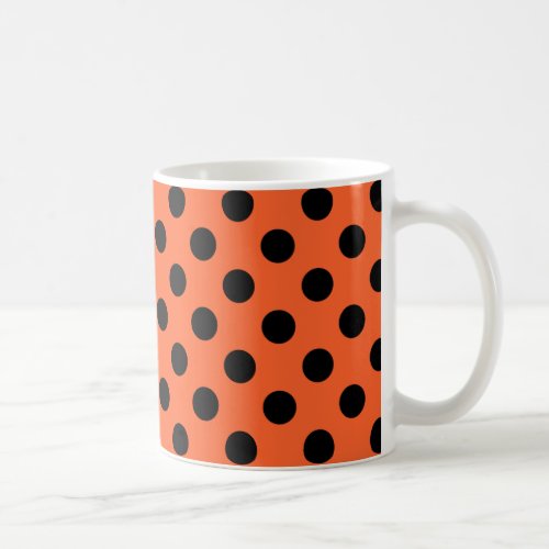 Black polka dots on orange coffee mug