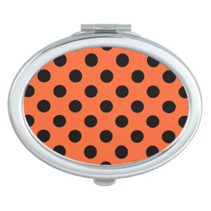 Black polka dots on orange makeup mirror